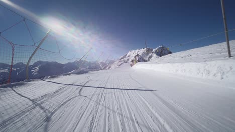 first-person-view-POV:-Skier-skiing-with-amazing-mountain-scenery-in-swiss-alps-on-perfect-slopes