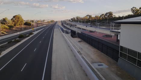 Freeway-traffic-and-Clarkson-train-station,-Perth-Australia