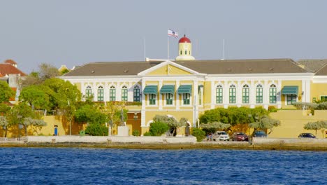 The-House-Of-Parliament-In-Curacao-With-Yellow-Exterior-Facade---wide-shot