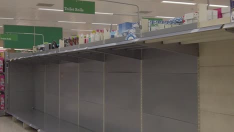 Slow-motion-interior-empty-UK-supermarket-toilet-roll-aisle-panic-buying-corona-virus-retail