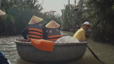 Adults-in-Cone-Hats-Riding-Down-the-River-in-a-Round-Basket-Boat