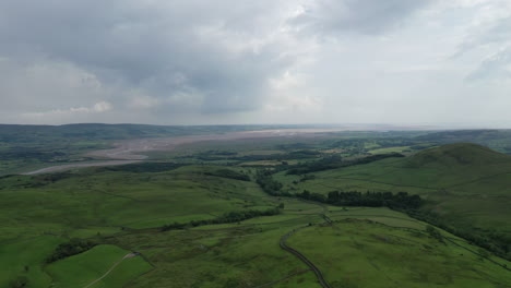 Aerial-shot-of-some-rural-farmland-on-the-North-West-coast-of-England,-bright-but-cloudy-day