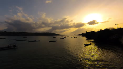 TimeLapse---Sunrise-over-Ceningan-Island-,-boats-bobbing-around-in-ocean-straight