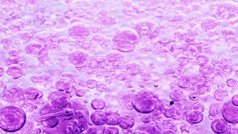 macro-shot-of-violet-bubbles-in-water-floating-right-with-yellow-background