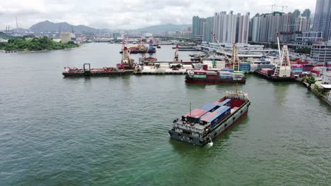 Small-Feeder-class-Container-ship-in-Hong-Kong-bay,-Aerial-view