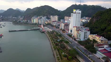 Hung-Long-Harbor-on-Lan-Ha-Bay-with-main-ferry-pier-and-hotels-visible,-Aerial-dolly-in-shot