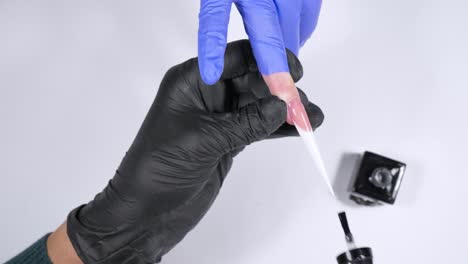 top-down-view-polishing-gel-being-applied-on-extreme-gel-nail-UHD