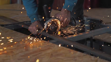 Man-working-construction-cutting-steel-with-Angle-grinder-slow-motion-sparks