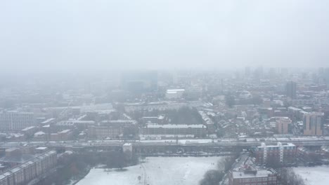 Aerial-drone-shot-of-residential-East-London-covered-in-heavy-Snow-Winter