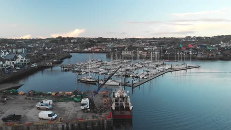 Kinsale-Harbour-during-winter-evening-with-the-view-over-fishing-boat,-yacht-marina-and-town-in-the-distance