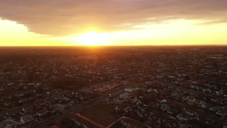 A-high-angle,-aerial-view-over-a-Long-Island-neighborhood-during-a-golden-sunrise