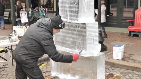 Ice-sculptor-sketching-on-ice-blocks-with-chisel