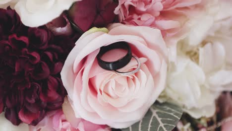 Roses-up-close-with-a-macro-lens-and-wedding-rings-posed-on-the-petals