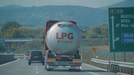 Following-A-Gasoline-Tanker-Trailer-Truck-Driving-On-A-hot-Highway-In-Bratislava,-Slovakia,-handheld,-POV-summer