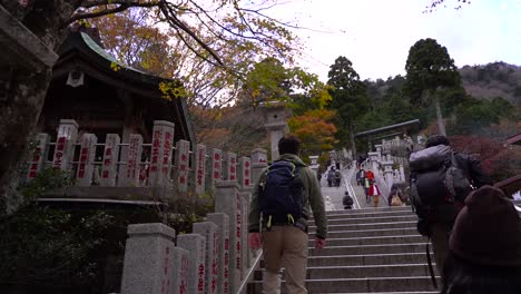 POV-slow-motion-walking-up-stone-steps-towards-temple-in-Asia-with-fall-colors