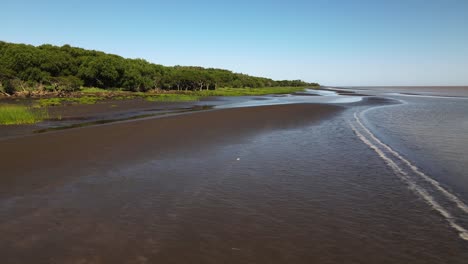 Low-aerial-pan-of-brown-sand-banks-and-swamp-by-Rio-de-la-Plata-coast