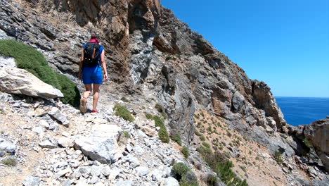 Hiking-woman-is-walking-on-the-rocks