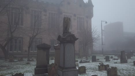 A-view-of-grave-headstones-in-a-foggy-graveyard