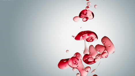 Transparente-Rote-Ölblasen-Und-Flüssige-Formen-Auf-Einem-Weißen-Hintergrund-Mit-Farbverlauf