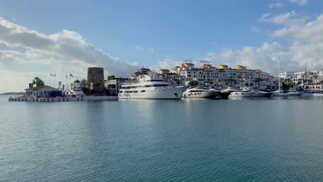 Gimbal-shot-view-of-expensive-yachts-in-Puerto-Banus-harbor,-Marbella-luxury-jet-set-lifestyle