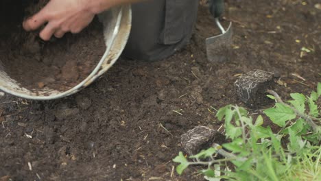 Mixing-compost-and-soil-in-bucket-gardening