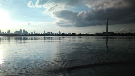 A-beautiful-motion-time-lapse-of-a-distant-Toronto-skyline-at-sunset,-seen-from-the-Leslie-Spit