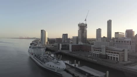 RFA-Navy-Tiderace-military-tanker-on-Liverpool-cityscape-waterfront-at-sunrise-aerial-view-low-orbiting-right