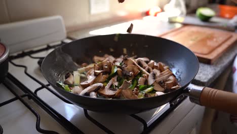 Sliced-Mushrooms-Falling-Into-The-Pan-With-Green-Squash-And-Parsley-Cooking-In-The-Kitchen