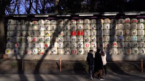 People-looking-at-Sake-Barrels-at-famous-Meiji-Shrine-in-Tokyo