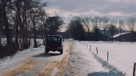 slow-motion-4x4-old-off-road-car-moving-through-snow-covered-country-road