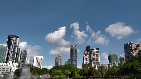 Time-lapse-video-of-fountain-show-at-KLCC-Park-with-commercial-building-and-tower-at-background-with-bright-blue-sky