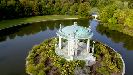 Gazebo-with-Stone-Columns-in-Old-Fashioned-Romantic-Venue-Surrounded-by-Water---Aerial-Drone-Orbit-Establishing-View