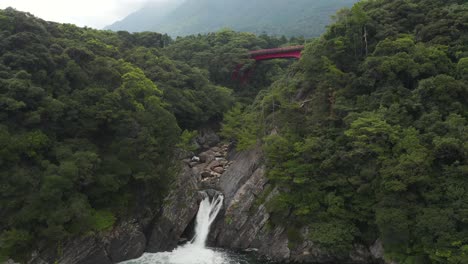 Torokino-Falls-in-Yakushima,-Tilt-Up-Reveal-of-Misty-Mountain-In-Japan