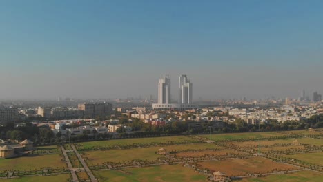 Aerial-Flyover-Nooruddin-Zangi-Park-With-Com3-Mall-in-Distance