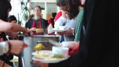 School-Canteen-Staff-Serving-Meals-To-Students-In-Waldorf-School,-Netherlands---medium-shot