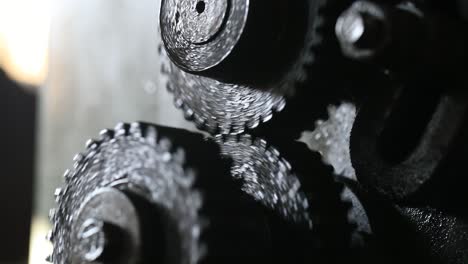 two-engineers-seen-through-a-large-cogwheels-gear-shaft,-metal-industry
