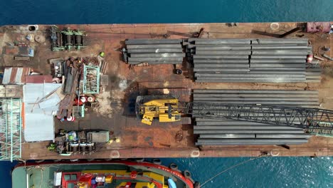 Ascening-aerial-top-down-of-metal-pipes-on-ferry-ship-during-sunny-day-in-Asia