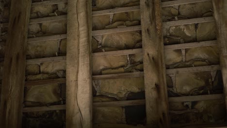 Wooden-roof-beams-on-old-building-medium-panning-shot