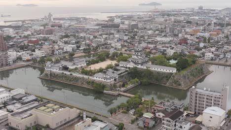 Imabari-Castle-and-City,-Aerial-Tilt-Reveals-Japan-Inland-Sea
