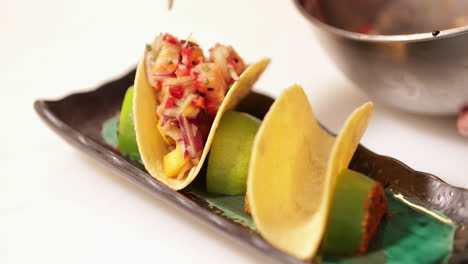 Chef-Filling-Taco-Shells-With-Chopped-Vegetables-And-Fish