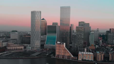 Cinematic-rotating-Drone-aerial-shot-of-London-Canary-Wharf-at-sunset