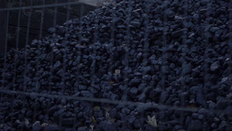 Coal-supply-stored-outdoors-wide-panning-shot