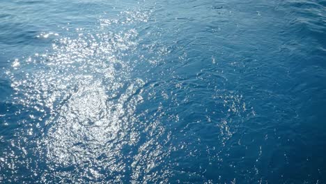 Sunlight-Reflection-In-The-Blue-Sea---View-From-A-Sailing-Boat---high-angle-shot