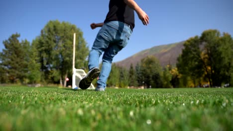 Man-kicking-soccer-ball-in-slow-motion