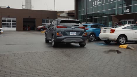Tracking-Shot-Following-a-Hyundai-Kona-Pulling-into-a-Car-Dealership