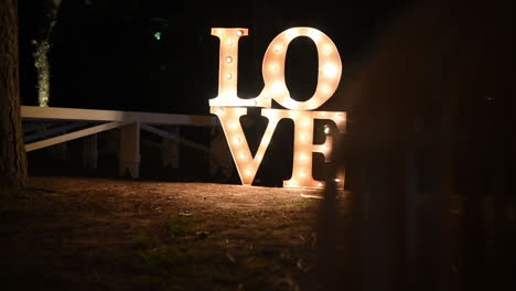 LOVE-Lightning-Letter-Shining-on-Field-In-The-Night,-Cinematic-View,-Wedding-and-Proposal-Concept