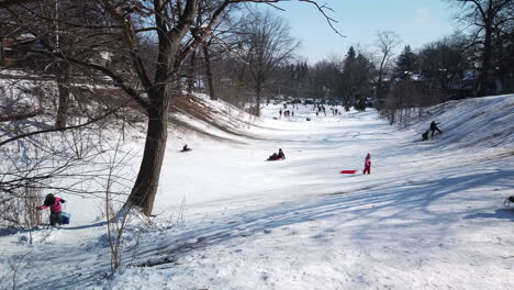 Wide-shot-of-community-toboggan-hill-with-skating-rink-in-the-distance