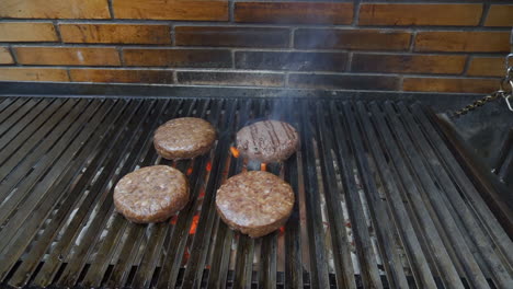 Burgers-on-the-grill,-flames-coming-out