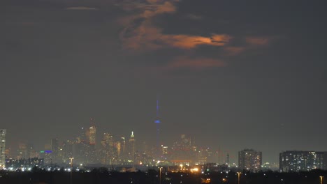 Time-lapse-of-giant-moon-rising-over-Mississauga,-Toronto,-Canada,-wide-shot