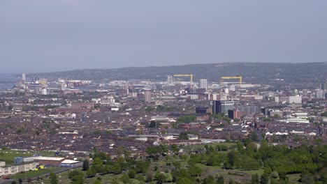 Aerial-flyover-of-west-Belfast-from-the-countryside-looking-towards-the-city-centre-or-center